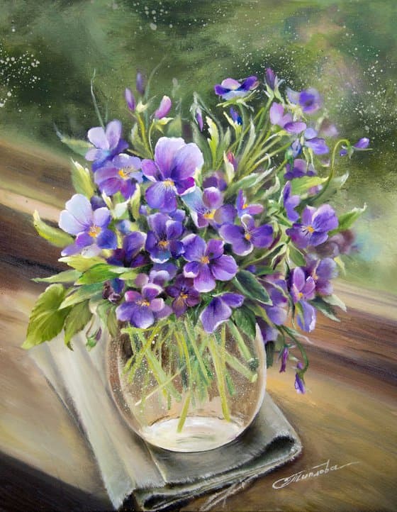 Pansies in glass vase